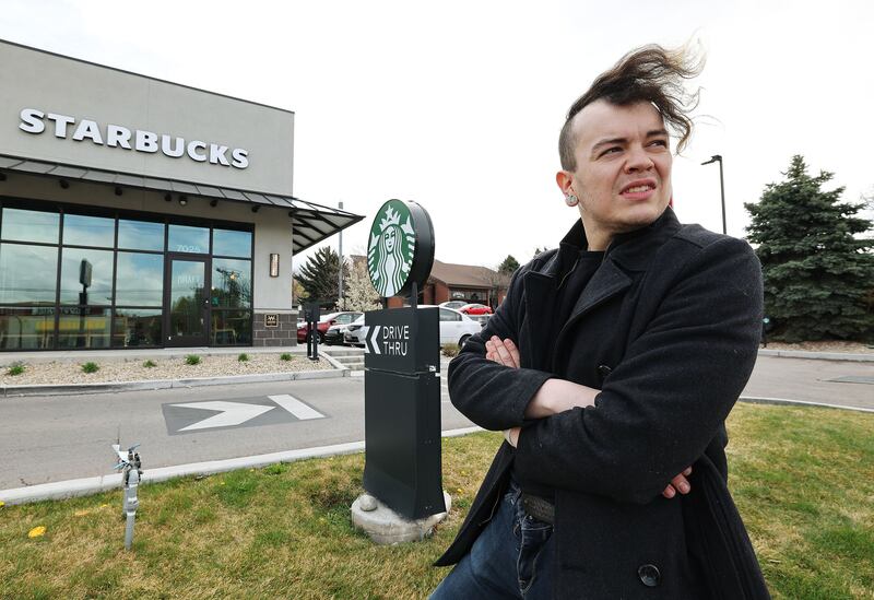 Starbucks employee Jacob Lawson stands near the chain’s coffee store in Cottonwood Heights on Friday, April 15, 2022.