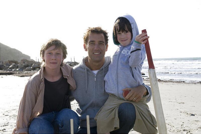 From left, George MacKay plays Harry, Clive Owen is Joe and Nicholas McAnulty is Artie in "The Boys Are Back."