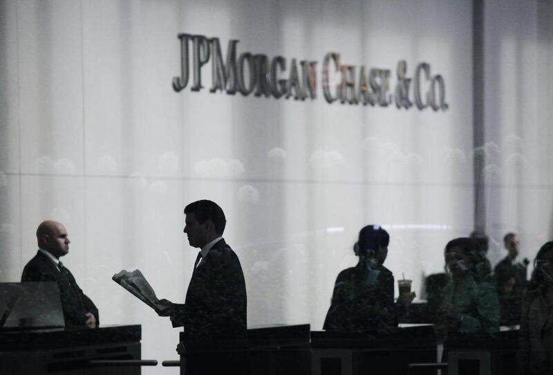 People arrive at JPMorgan Chase headquarters in New York Monday, May 14, 2012.