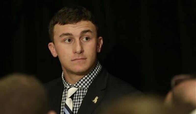 Texas A&M quarterback and Heisman Trophy winner Johnny Manziel talks with reporters during the Southeastern Conference football Media Days in Hoover, Ala., Wednesday, July 17, 2013. Manziel made quite a stir during the football offseason for himself. In s