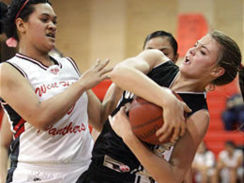 West's Fusi Lutui and Highland's Makensie Pratt battle for the ball in Friday's Region 6 game.
