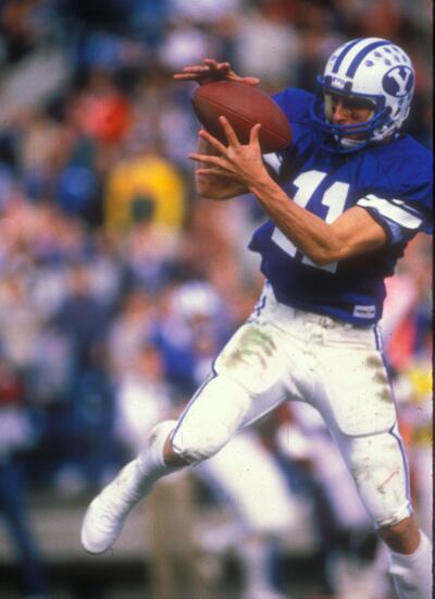 BYU receiver Mark Bellini makes a catch during a BYU victory in Provo in 1984. The Cougars finished the year with a perfect record, a victory in the Holiday Bowl over Michigan, and a national championship.