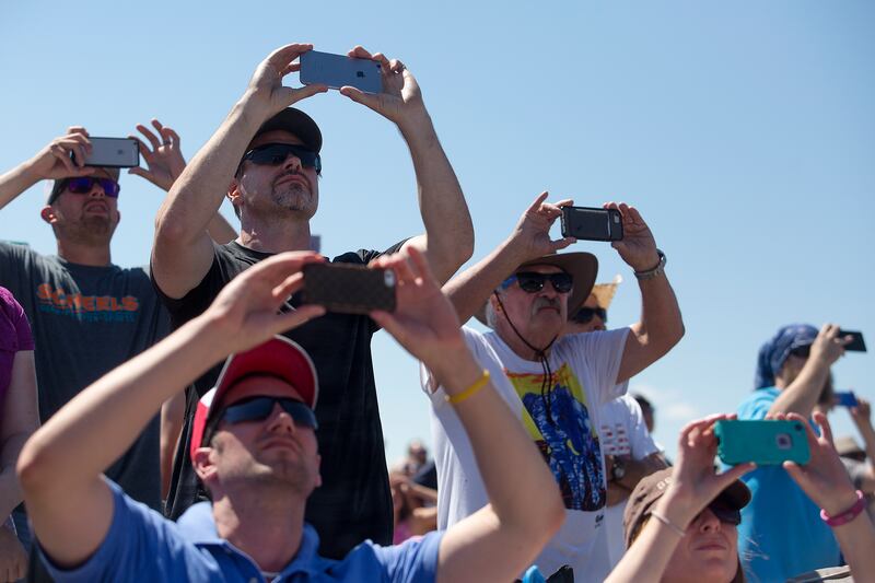 Spectators film the Thunderbirds on their phones during the Warriors Over the Wasatch Air and Space Show at Hill Air Force Base on Saturday, June 23, 2018.