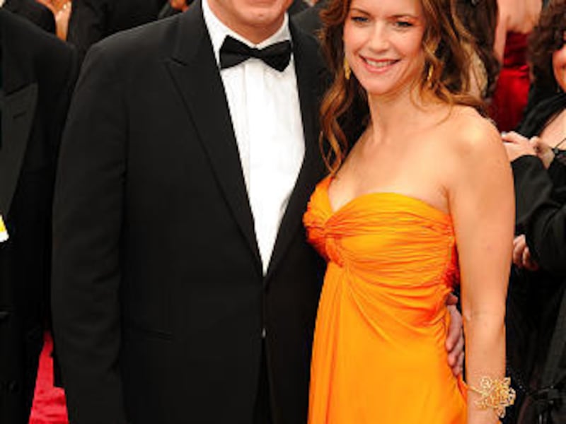 John Travolta and his wife, actress Kelly Preston, stop to pose for photographers at a red carpet event last year. Travolta's teenage son died in Grand Bahama after apparently having a seizure and hitting his head at his family's vacation home.