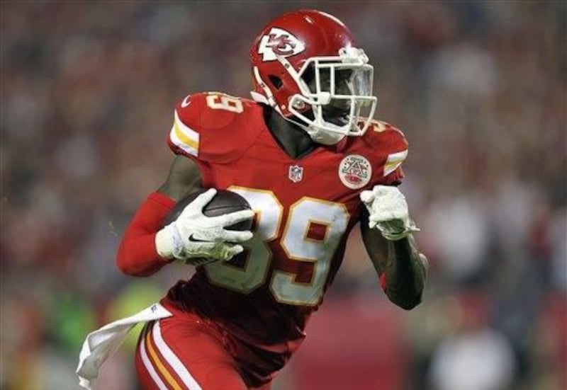 Kansas City Chiefs free safety Husain Abdullah carries the ball after intercepting a pass and running it back 39 yards for a touchdown during the fourth quarter of an NFL football game against the New England Patriots, Monday, Sept. 29, 2014, in Kansas Ci