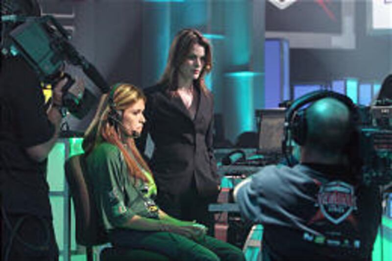 In this photo released by CGS, Vanessa Arteaga, left, of the San Francisco Optx, concentrates during a shutout Dead or Alive match as her General Manager Kat Hunter, right, looks on at the Championship Gaming Series.