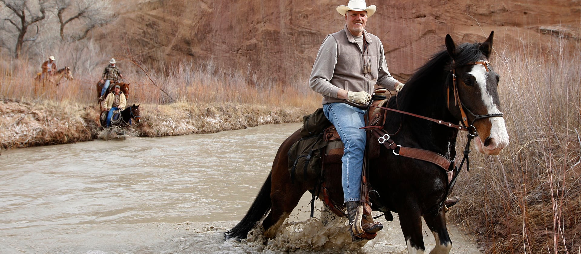 Mark Eaton rides his Clydesdale/Thoroughbred horse “Big Tim” down Little Grand Canyon of the San Rafael Swell.