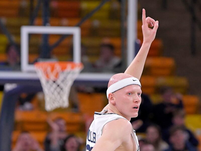Utah State guard Brock Miller celebrates after a teammate made a basket.