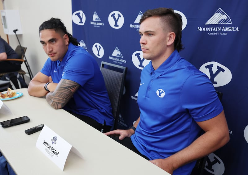 BYU linebackers Keenan Pili, left, and Payton Wilgar are interviewed during BYU football media day in Provo, June 22, 2022.