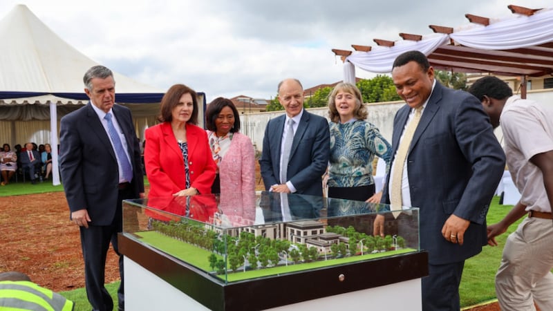 The three members of the Africa Central Area presidency and their wives look at a scale model of the new area office building in Nairobi, Kenya.