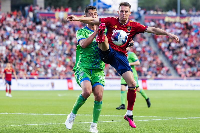 Real Salt Lake forward Danny Musovski (17) leaps in front of Seattle Sounders defender Jackson Ragen (25).