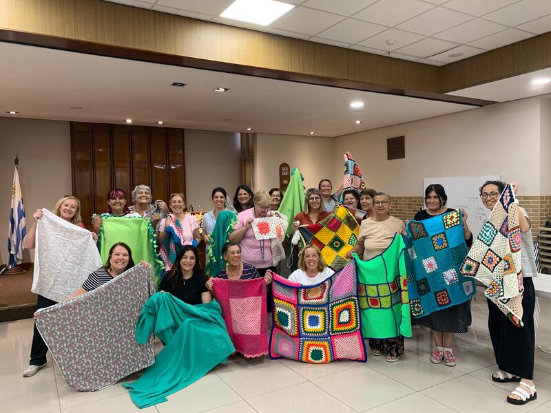 Women in a group called Las Liebres (the Hares) show some of the blankets they have made for children in hospitals around Uruguay in January 2025.