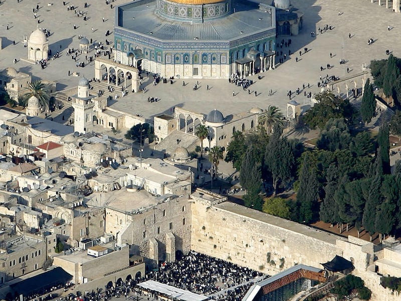 In this aerial photo from 2005, Muslim worshippers gather outside the Dome of the Rock Mosque, in the Al Aqsa Mosque compound, also known to Jews as the Temple Mount, and Jews gather at the Western Wall, bottom center, the holiest site where Jews can pray