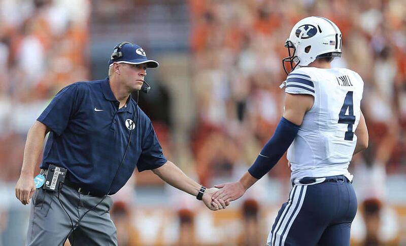 BYU Head Coach Bronco Mendenhall gives his quarterback, Taysom Hill five after a score as BYU and Texas play Saturday, Sept. 6, 2014, in Austin Texas.
