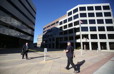 People walk by the scene of a fatal shooting between the Heber M. Wells Building and the Olene S. Walker Building in Salt Lake City on Wednesday, June 20, 2018.
