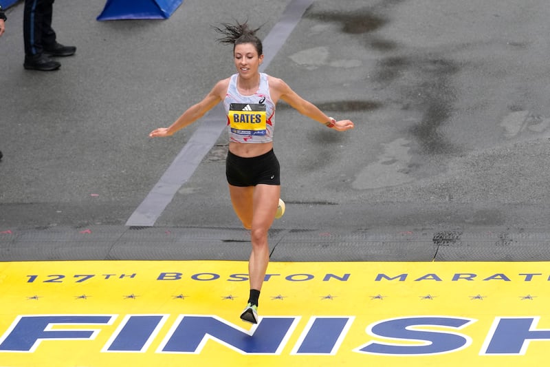 Emma Bates crosses the finish line of the Boston Marathon.