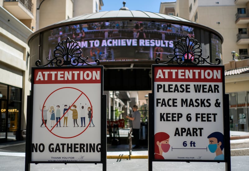 Signs with social distancing guidelines and face mask requirements in Los Angeles