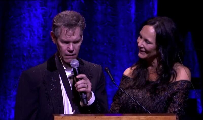 Randy Travis sings "Amazing Grace" with his wife, Mary Davis Travis, at the Country Music Hall of Fame induction ceremony on Sunday.