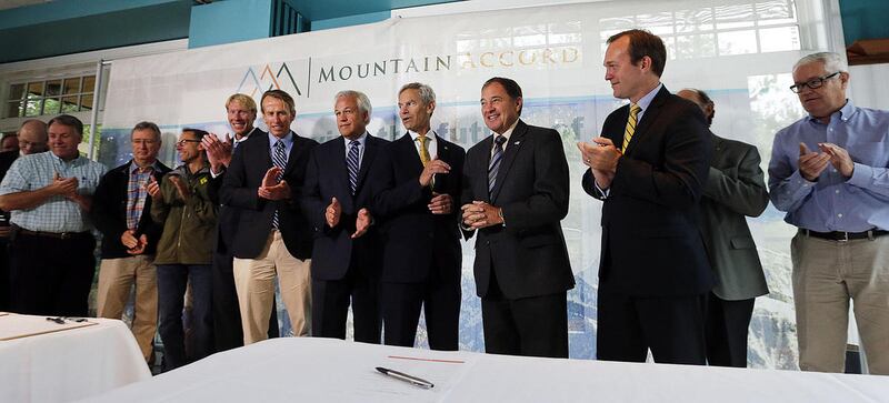 Dignitaries applaud after Gov. Gary Herbert signs the Mountain Accord in Cottonwood Heights, Monday, Aug. 3, 2015.