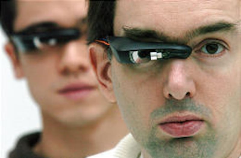 Steve Mann, an eccentric University of Toronto engineering professor, right, and graduate student Chris Aimone are wearing the EyeTap digital eye glass.