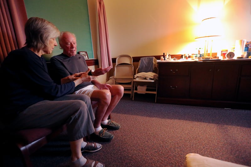 Jim and Catherine Gibbons talk while sitting in a shelter at an LDS meetinghouse in Stony Point, Santa Rosa, California, during a wildfire on Sunday, Oct. 15, 2017.