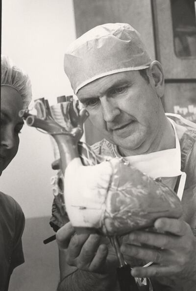Dr. Russell M. Nelson holds a model of the human heart.