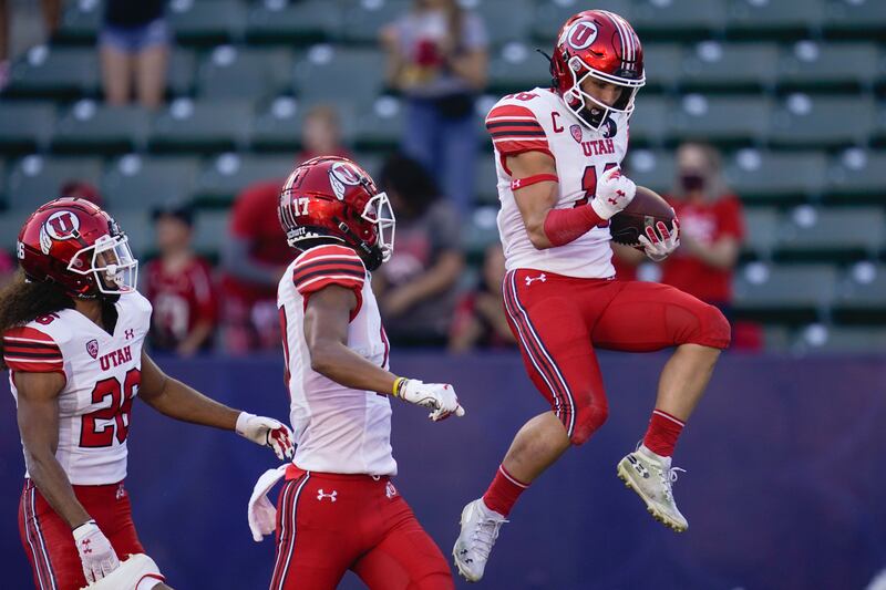 Utah’s Britain Covey celebrates after returning a punt for a TD during game against San Diego State in Carson, Calif.