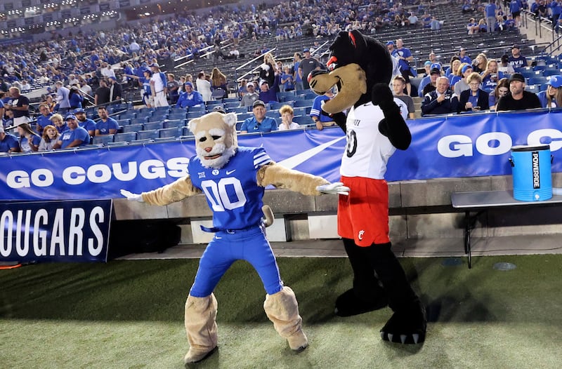 Cosmo and Bearcat interact before the Brigham Young Cougars play the Cincinnati Bearcats at LaVell Edwards Stadium in Provo on Friday, Sept. 29, 2023.