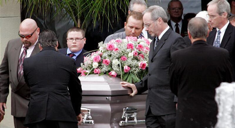 Friends and family of Melanie Billings carry her coffin from a church in Pensacola, Fla., to a waiting hearse after her and her husband's funeral on Friday.