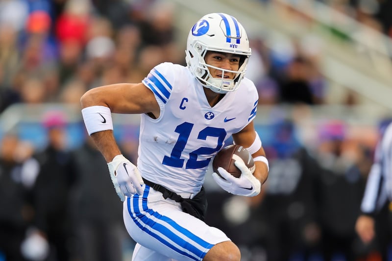 BYU wide receiver Puka Nacua runs with the ball after a reception against Boise State. Nakua has declared for the NFL draft.