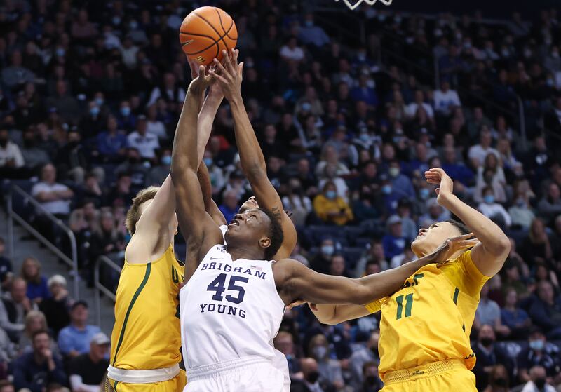 BYU forward Fousseyni Traore battles for a rebound over San Francisco Dons forward Patrick Tape in Provo on Feb. 3, 2022.
