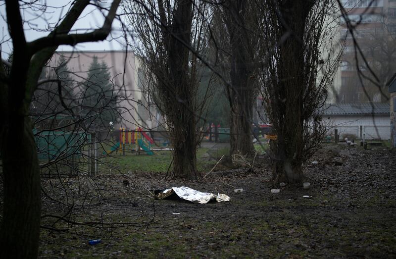 A body on the ground at the scene where a helicopter crashed in Brovary, on the outskirts of Kyiv, Ukraine, Jan. 18, 2023.