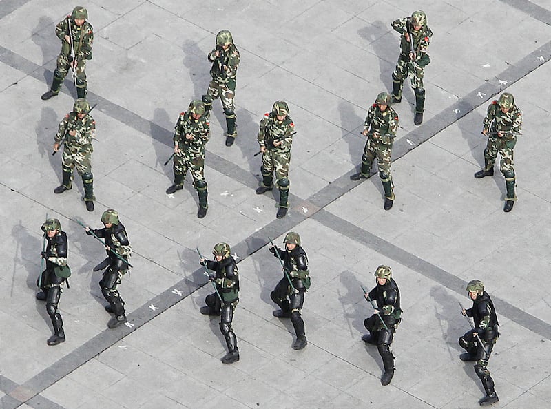 In this July 15, 2009 file photo, paramilitary police officers train themselves at the People's Square in Urumqi, in western China's Xinjiang province. China has sent an elite anti-terrorism unit to the restive far western region of Xinjiang in the wake o