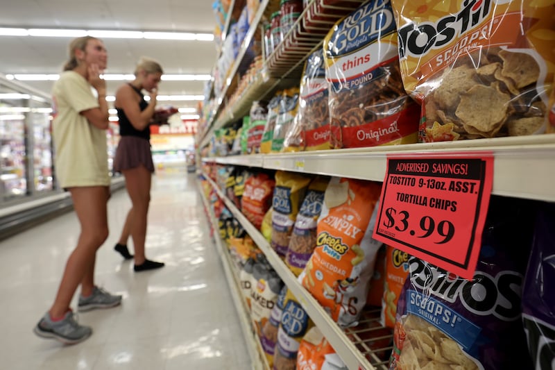 Elle Johnsen and Maddy La Fleur shop for chips at a Reams in Sandy, Utah.