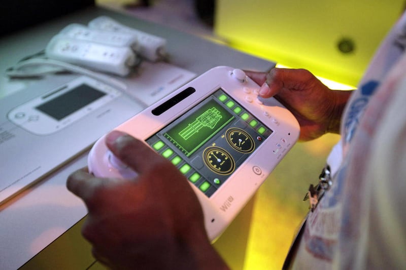 An attendee plays a video game using Nintendo’s Wii U controller at E3 2012 in Los Angeles, Tuesday, June 5, 2012.