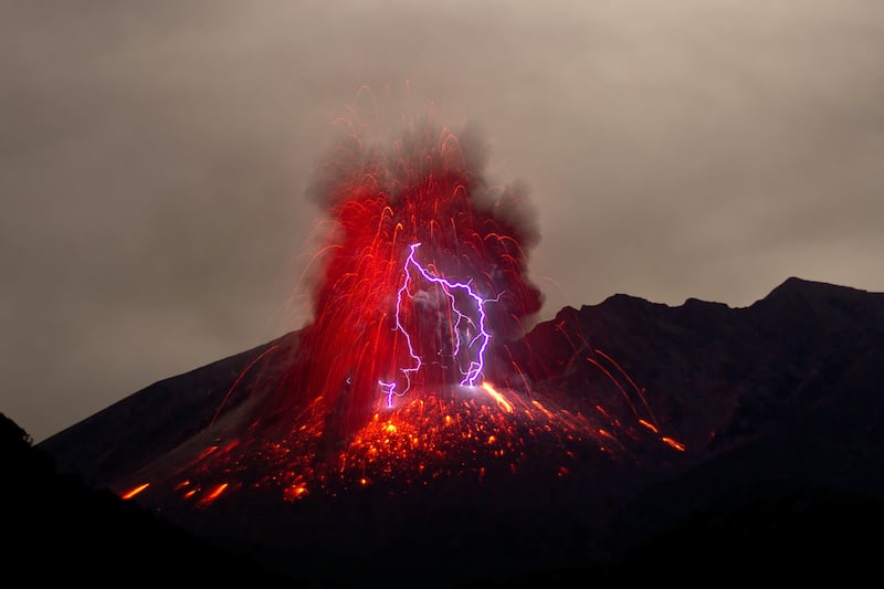 Sakurajima Volcano on the Japanese island of Kyushu showcases red and purple volcanic lightning in 2013.