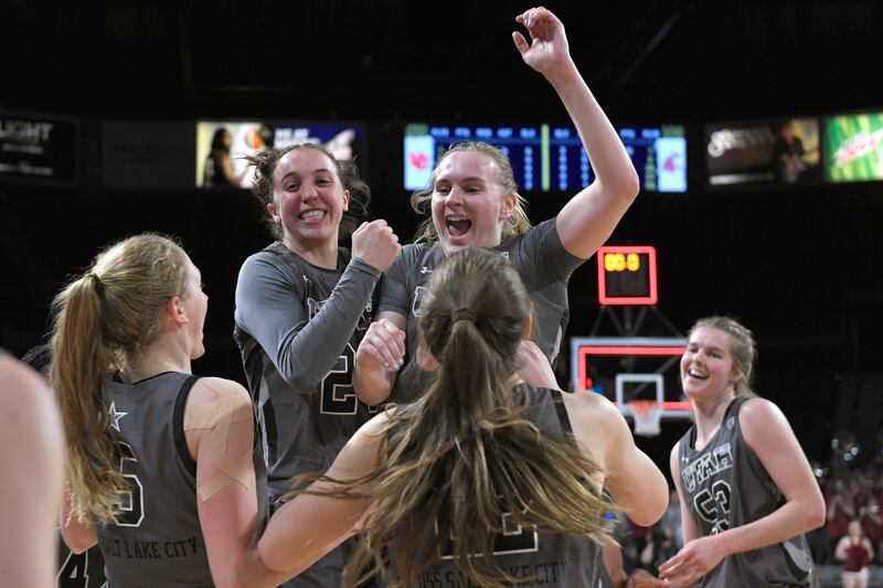 Utah players jump and celebrate a victory