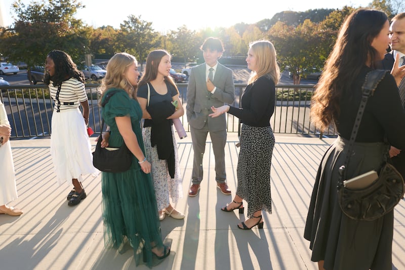 Young adults gather outside the Washington D.C. Temple before attending a devotional with Elder Neil L. Andersen and his wife, Sister Kathy Andersen, on Oct. 18, 2025.