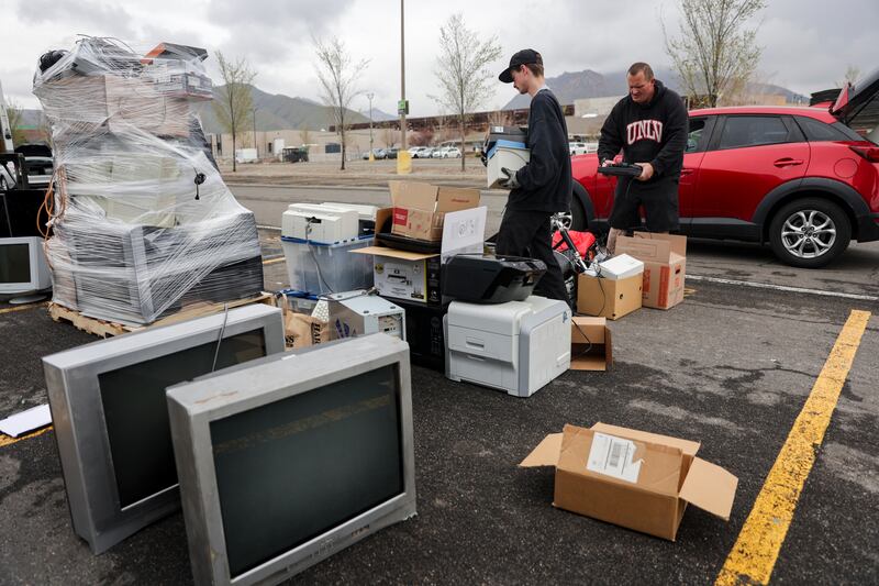 Aden Cornaby of Tams Electronic Recycling and Jesse Graham of The Other Side Academy organize electronics for recycling.