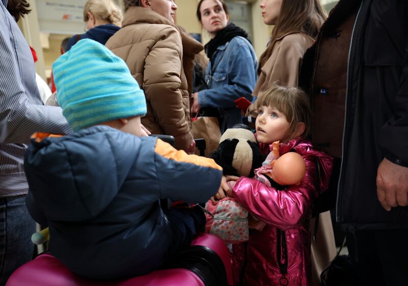 Ukrainian refugee Victoria Teslia waits with her mother and brother at the Przemysl Glowny train station in Przemysl, Poland.