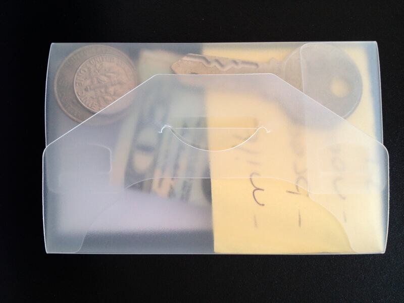 FILE - This undated photo provided by researchers in June 2019 shows an example of a transparent wallet used in an experiment to test how likely people are to return a lost wallet. "The evidence suggests that people tend to care about the welfare of other
