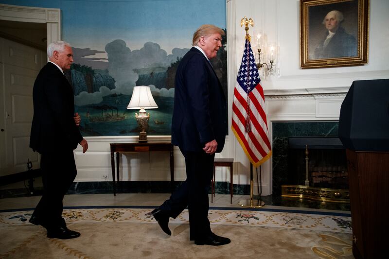 Vice President Mike Pence follows President Donald Trump as he arrives to speak about the mass shootings in El Paso, Texas and Dayton, Ohio, in the Diplomatic Reception Room of the White House, Monday, Aug. 5, 2019, in Washington. (AP Photo/Evan Vucci)