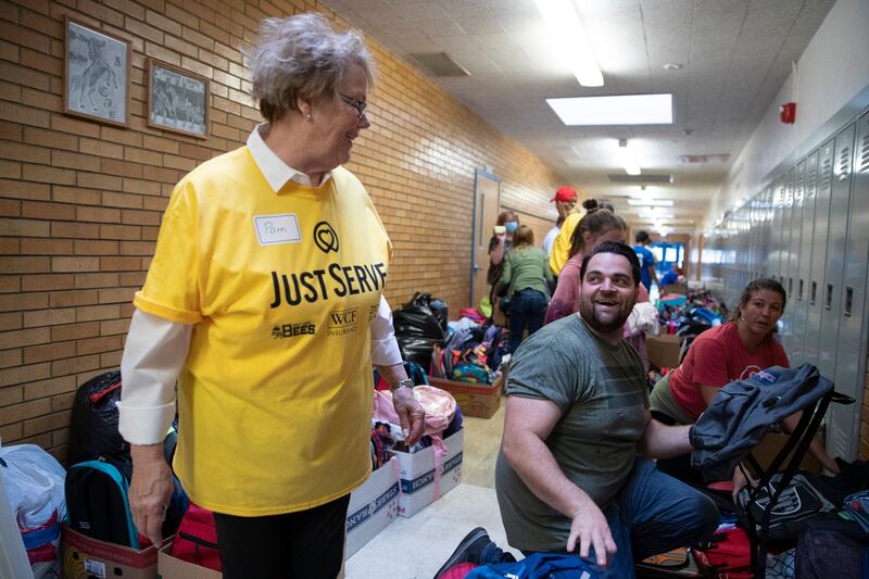 Pam White shares a light moment with Pastor Austin Glenn during a service project.