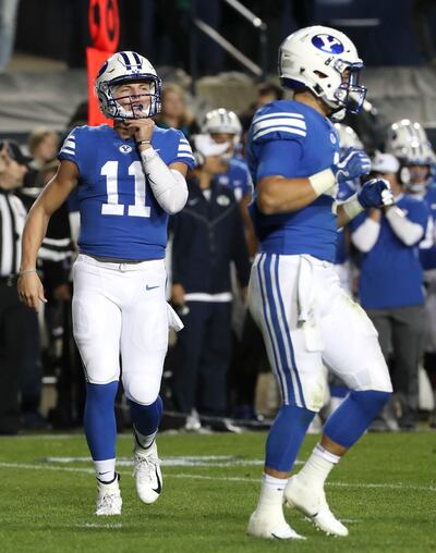 Brigham Young Cougars quarterback Zach Wilson (11) checks into the game late in the fourth quarter of the Utah State versus BYU football game at LaVell Edwards Stadium in Provo on Friday, Oct. 5, 2018.