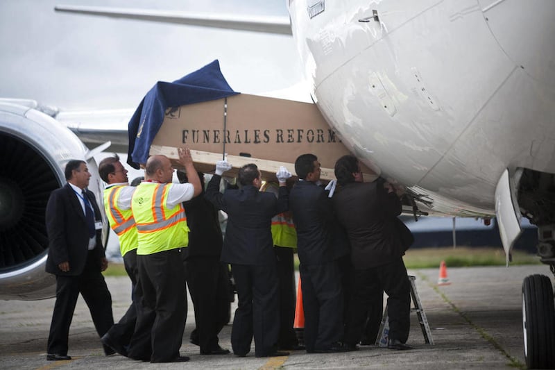 Funeral workers load into an airplane heading to Argentina, a coffin containing the body of murdered Argentine folk singer Facundo Cabral in Guatemala City, Monday, July 11, 2011. One of Latin America's most admired folk singers, Facundo Cabral, was kille