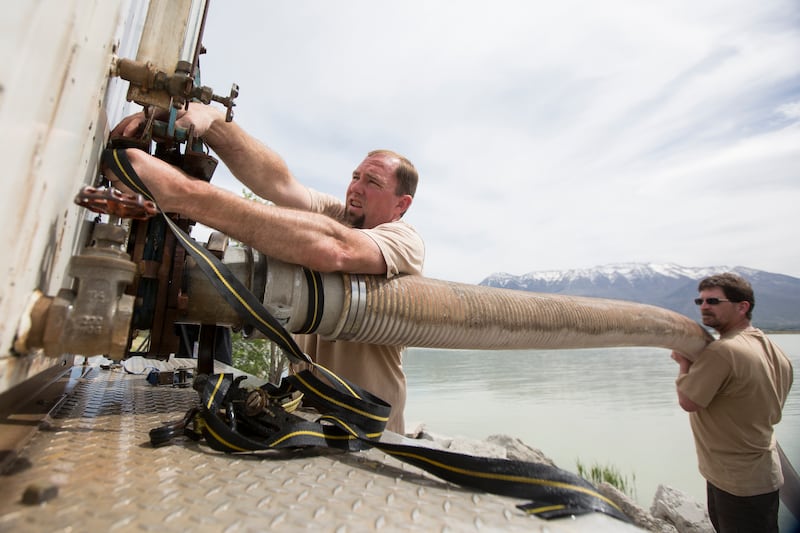Gary Howes and Keith Lawrence, of the Division of Wildlife Resources, prepare a tube through which June suckers will be released into Utah Lake at the American Fork Boat Harbor in American Fork on Monday, May 7, 2018.