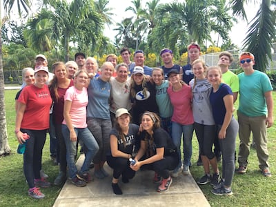 Amy Antonelli, CEO of Deseret Network International, smiles with an HEFY group in Tonga in July 2017.
