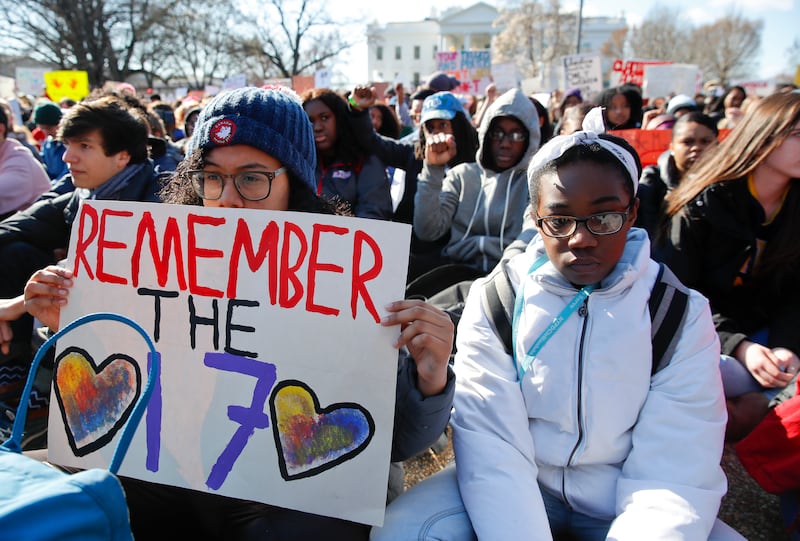 Students sit in silence as they rally in front of the White House in Washington, Wednesday, March 14, 2018. Student walked out of school to protest gun violence in the biggest demonstration yet of the student activism that has emerged in response to last