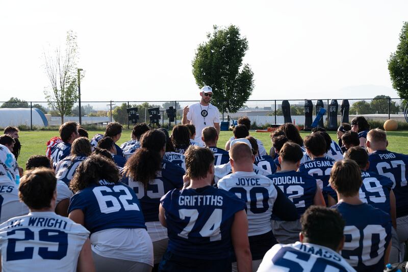 Utah State interim head coach Nate Dreiling addresses his team during fall camp in Logan.
