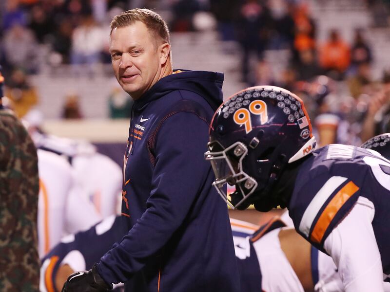 Former Virginia coach Bronco Mendenhall talks with players during warmups with Notre Dame in Charlottesville, Va., on Nov. 13, 2021.